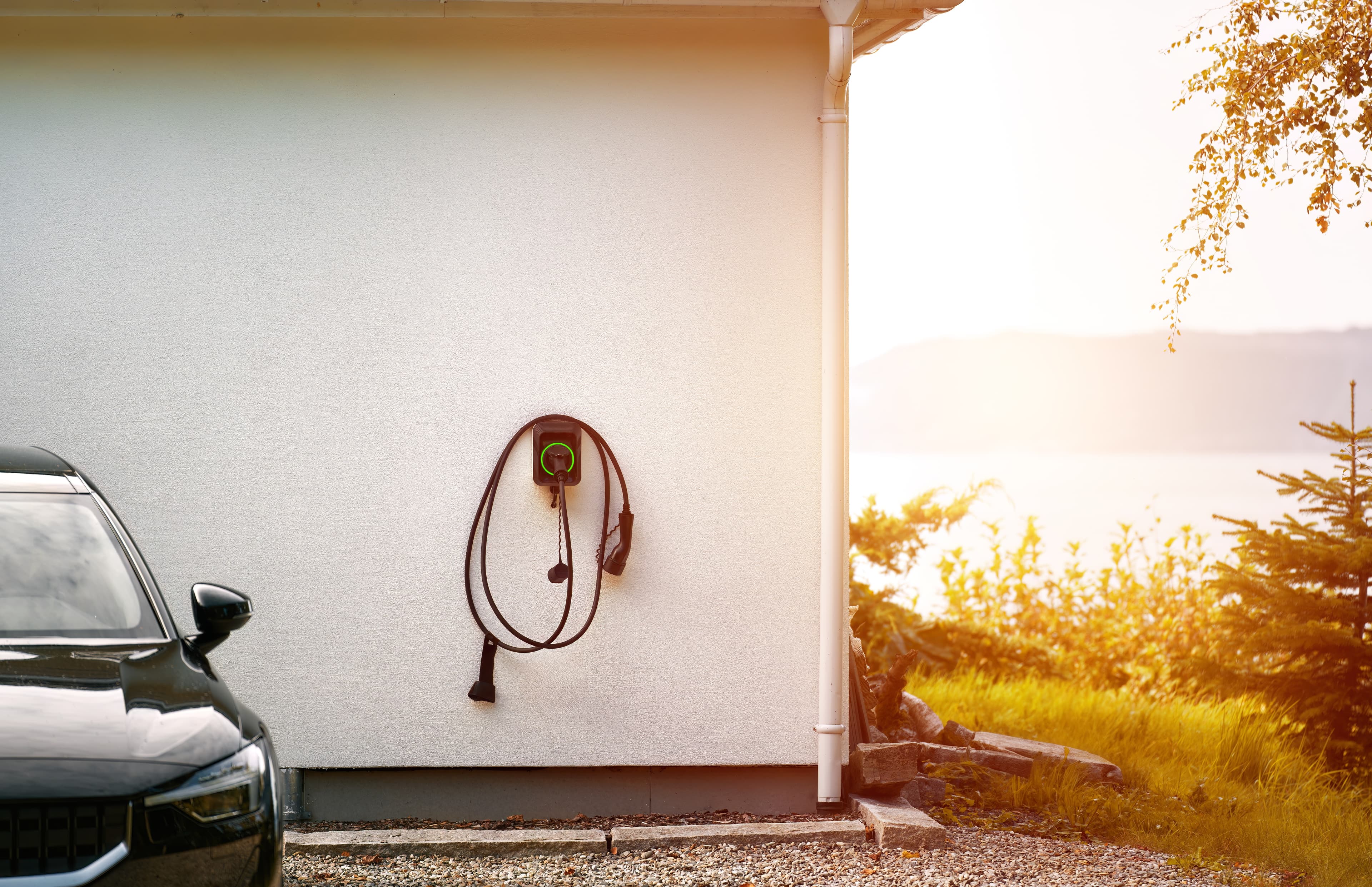 Wall mount EV charger plug holder in a garage